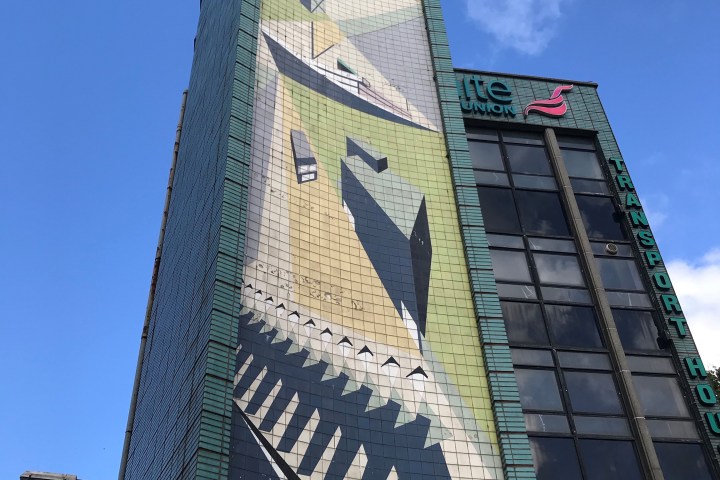 a large tall tower with a clock on the side of a building