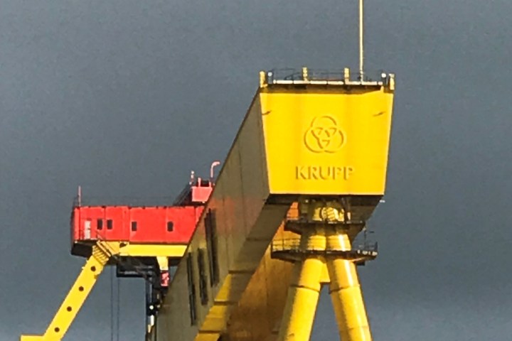 a large yellow sign on a pole