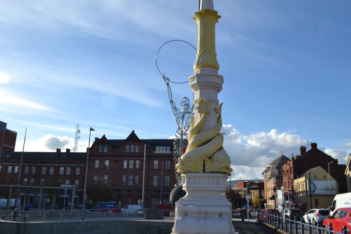a group of people around a tall building